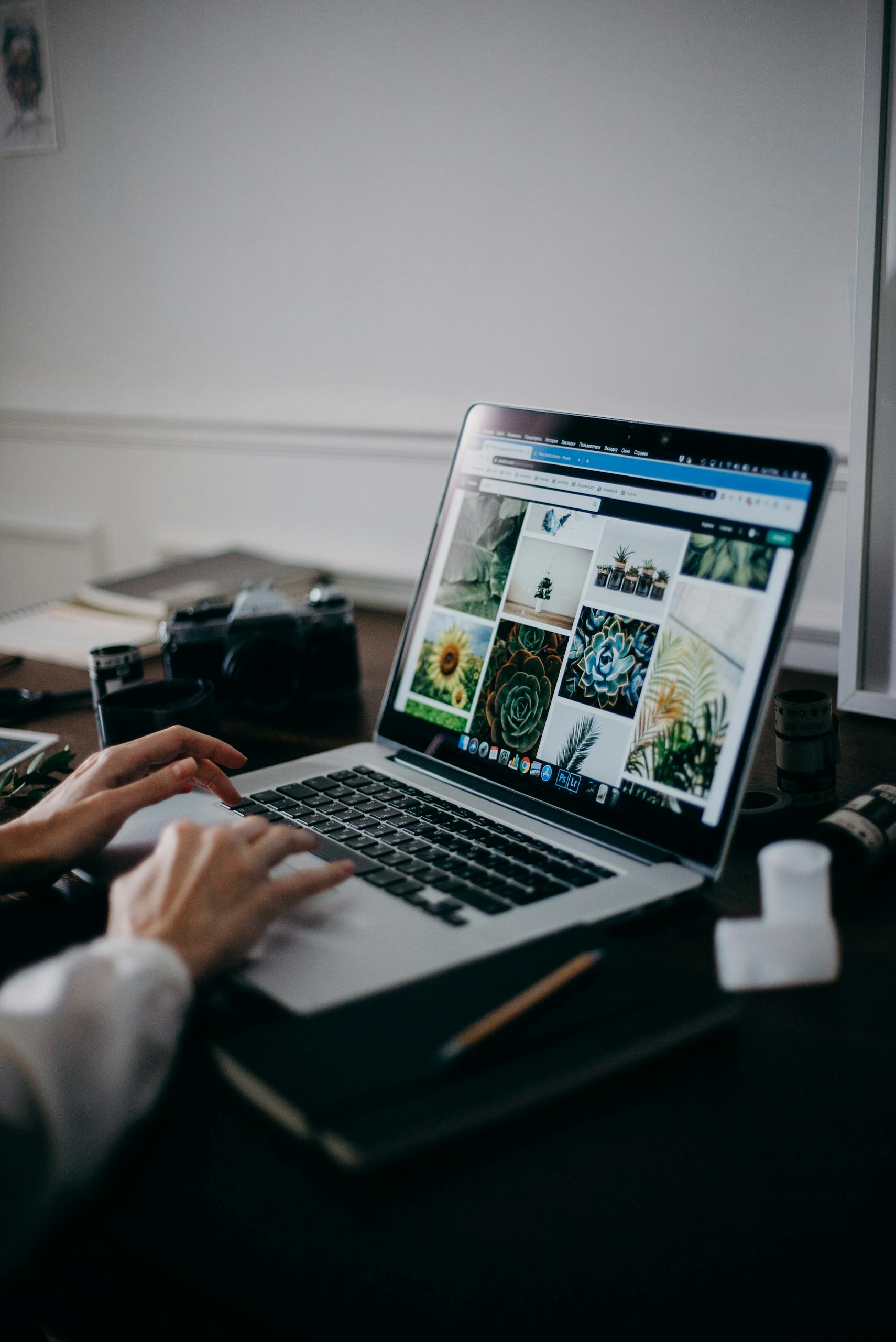 Person Using Macbook Pro On Table